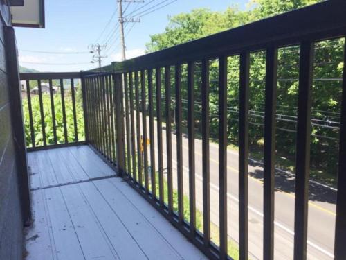 a balcony with black railings on a house at Kohan no yado Kojima - Vacation STAY 34143v in Lake Toya