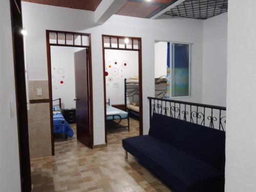 a living room with a blue couch and a mirror at CÓMODO APARTAMENTO CENTRAL EN BARRIO SEMI RURAl in Villavicencio