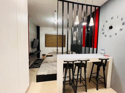 a kitchen with a bar with stools and a bed at *Top Choice Awardee B 2023 in Iloilo City