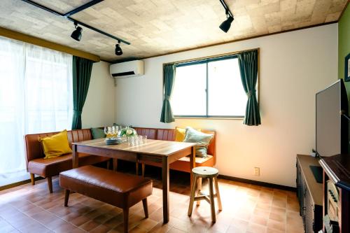 a dining room with a table and chairs at Ikken House in Tokyo