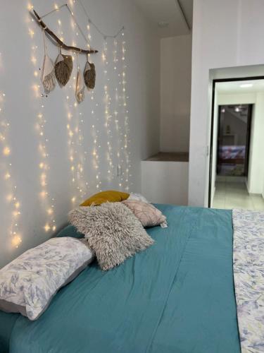 a bedroom with a bed with lights on the wall at CASA SAMANTA in Guadalajara