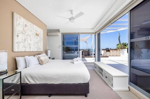 a bedroom with a large bed and a large window at Waterview Penthouse - Cote D'Azur Resort, Nelson Bay in Nelson Bay