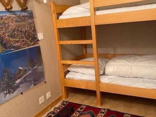 Cette chambre comprend des lits superposés et des lits superposés. dans l'établissement Studio cosy avec parking privatif aux Gets - FR-1-671-5, aux Gets