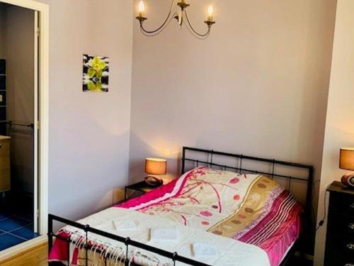 Dormitorio pequeño con cama con manta rosa en Appartement Amélie-les-Bains-Palalda, 2 pièces, 2 personnes - FR-1-703-153, en Amélie-les-Bains-Palalda