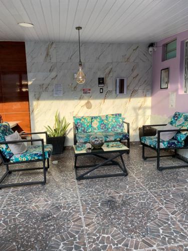 a living room with two chairs and a couch at Residencial Napolitan in Manaus