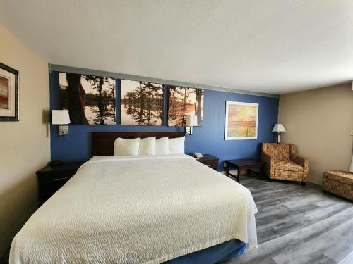 A bed or beds in a room at Days Inn by Wyndham Rosenberg