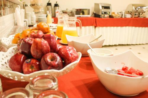 a table with bowls of fruit on a table at Hotel B&V in Huancayo