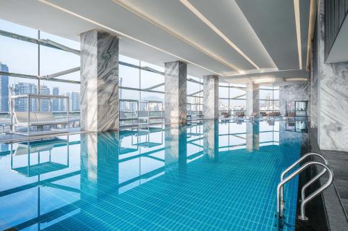 a pool on the top of a building at Renaissance Zhuhai Hotel in Zhuhai