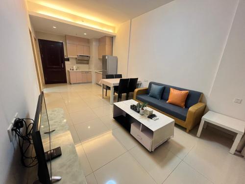 a living room with a couch and a table at Seaman Light Luxury Apartment in Zhongshan