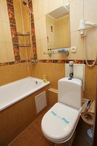 a bathroom with a toilet and a bath tub at LONDON in Petropavlovsk