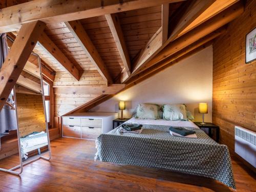 a bedroom with a bed in a room with wooden ceilings at Chalet Les Gets, 3 pièces, 8 personnes - FR-1-671-126 in Les Gets