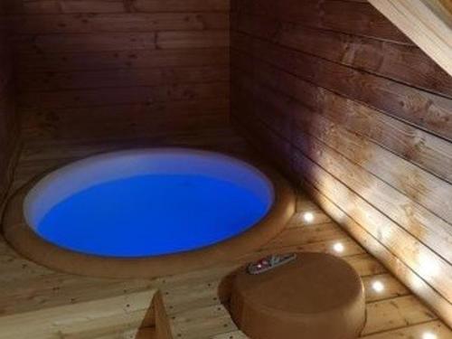 Cette chambre dispose de parquet et d'une baignoire bleue. dans l'établissement Spacieux appartement avec Wi-Fi et garage - FR-1-671-241, aux Gets