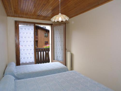 1 dormitorio con cama y ventana en Appartement Les Gets, 3 pièces, 5 personnes - FR-1-671-94, en Les Gets