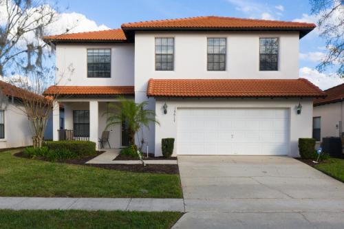 a white house with an orange roof at Paradise Resort Styles 4 BEDROOMS with 3 baths Pool and SPA in Orlando