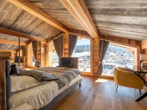 a bedroom with a bed and a large window at Chalet Les Gets, 7 pièces, 12 personnes - FR-1-671-138 in Les Gets