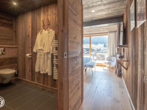 a room with wooden walls and a bathroom with a toilet at Chalet Les Gets, 7 pièces, 12 personnes - FR-1-671-138 in Les Gets