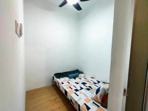 a bedroom with a bed with a ceiling fan at D'Aqiela Homestay @ ITCC in Penampang