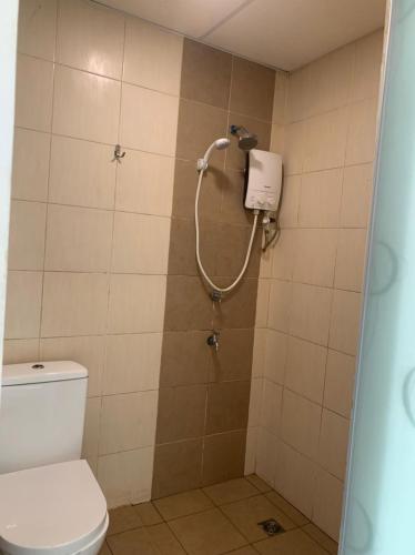 a bathroom with a shower with a toilet at D'Aqiela Homestay @ ITCC in Penampang