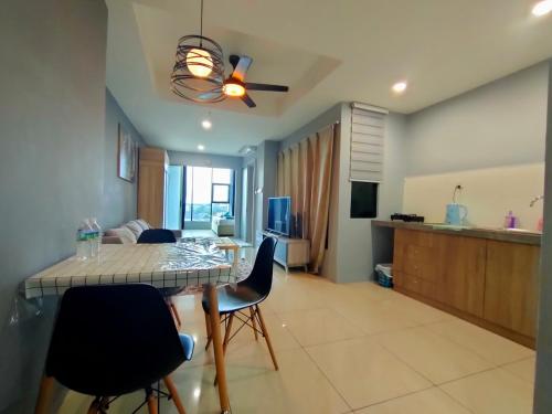 a kitchen and living room with a table and chairs at D'Aqiela Homestay @ ITCC in Penampang