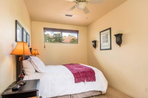 a bedroom with a bed and a ceiling fan at Uptown Sedona Gem: 3-Bed Townhome with Majestic Views and Central Location in Sedona