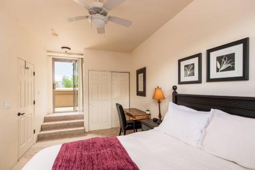 a bedroom with a bed and a desk and a window at Uptown Sedona Gem: 3-Bed Townhome with Majestic Views and Central Location in Sedona