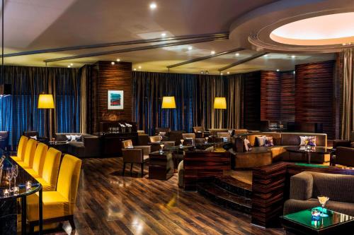 a hotel lobby with couches and a bar at Le Meridien Nagpur in Nagpur