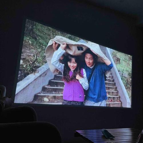 a tv screen with a picture of a man and a woman at Onheim in Tongyeong