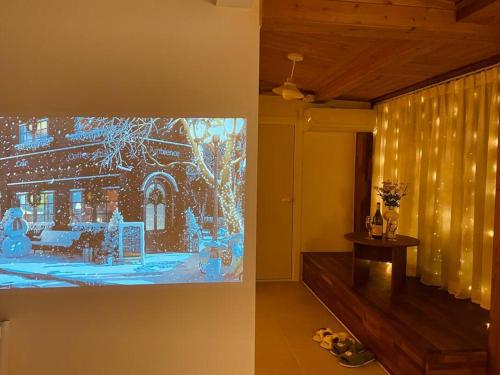 a living room with a tv on a wall at Onheim in Tongyeong