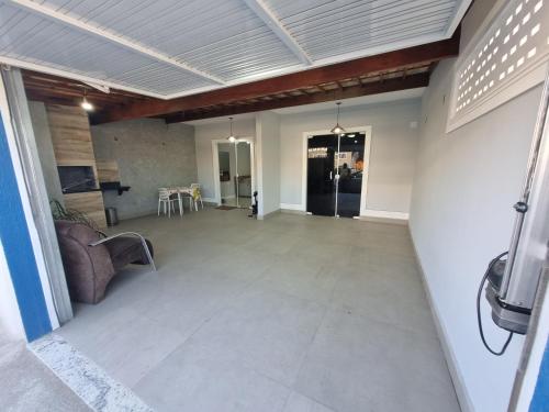 a living room with a couch and a table at Casa Nova Marilea in Rio das Ostras