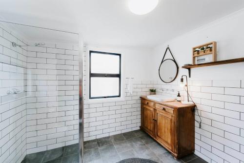 a bathroom with a sink and a mirror at 'Wilpine' Poolside Country Luxury near Town in Mudgee