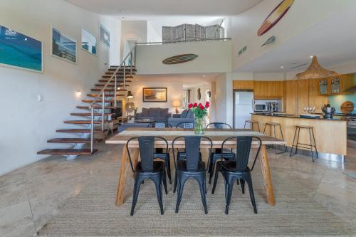 a dining room and living room with a table and chairs at Jades on Lawson 2 in Byron Bay