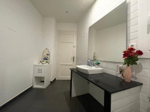a white bathroom with a sink and a mirror at Cathedral Barcelona Rooms in Barcelona