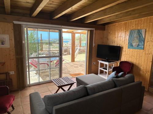 a living room with a couch and a flat screen tv at Casas Sol de Bolonia in Bolonia