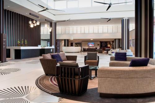 a lobby of a hotel with couches and chairs at Le Méridien Nouméa Resort & Spa in Noumea