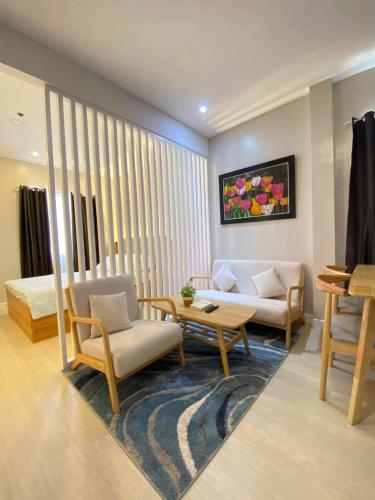 a living room with a couch and a table and chairs at Hyde Tower in Cebu City