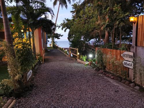 a path leading down to the beach at night at Marianita's cottages in Mambajao