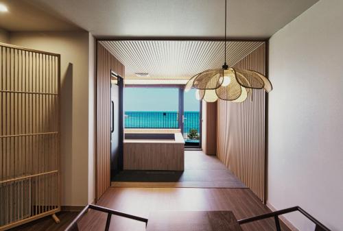 a hallway of a house with a view of the ocean at Gyeongju Denbasta Ryokan in Gyeongju