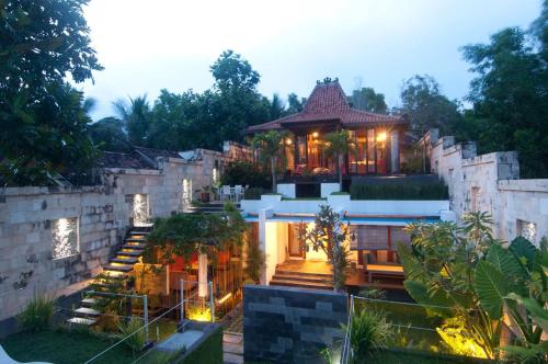 a house with stairs leading up to it at Villa Alcheringa Yogyakarta in Yogyakarta