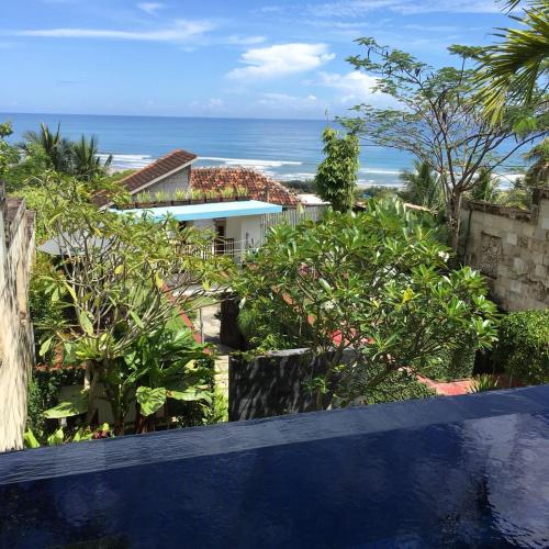 a view of the ocean from a balcony of a house at Villa Alcheringa Yogyakarta in Yogyakarta