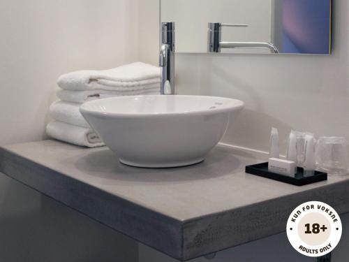 a white bowl sink on a counter in a bathroom at Ærø Hotel - Adults only in Marstal