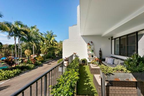 a balcony of a house with a fence at The Oasis Apartments and Treetop Houses in Byron Bay