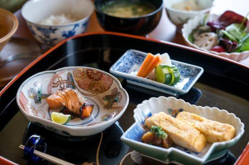 a tray with plates of food on a table at 宿坊　心月 in Arita