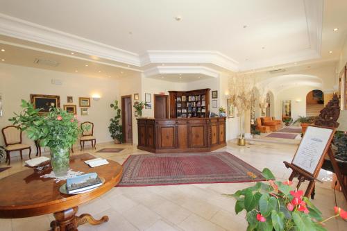 a large room with a table and chairs and a lobby at Torre Bennistra in Scopello