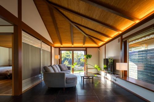 a living room with a couch and a bed at 宿坊　心月 in Arita