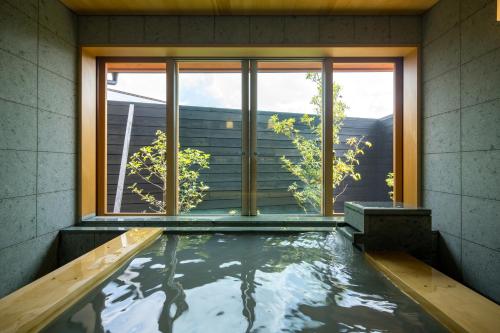 a swimming pool in a house with a window at 宿坊　心月 in Arita