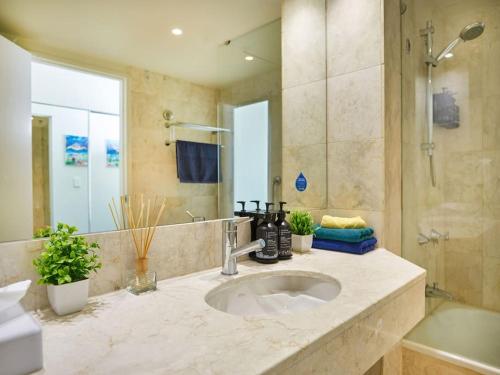 a bathroom with a sink and a shower at Stay in the heart of Surfers in Gold Coast