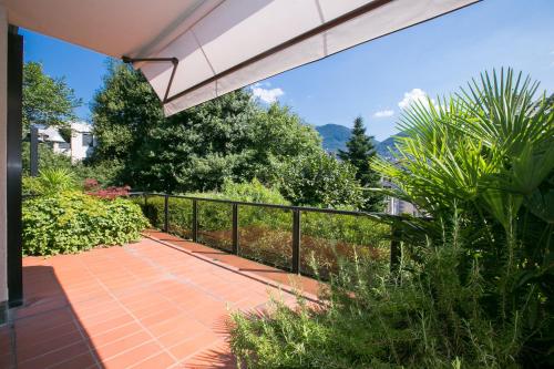 a patio with a fence and a walkway at Lugano Luxury - Happy Rentals in Lugano