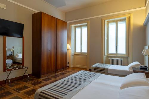 a hotel room with a bed and a mirror at Hotel Antica Dimora, MantegnaHotels in Mantova