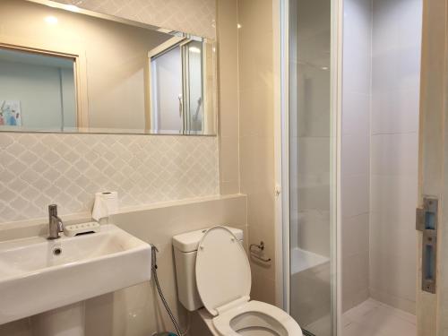 a bathroom with a toilet and a sink and a shower at 5 Floor - The Base Downtown Condominium next to Central Shopping Mall in Phuket