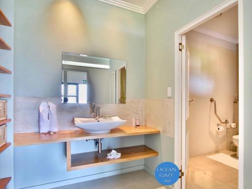 a bathroom with a sink and a mirror at Ocean Gaze Bed and Breakfast in Ramsgate